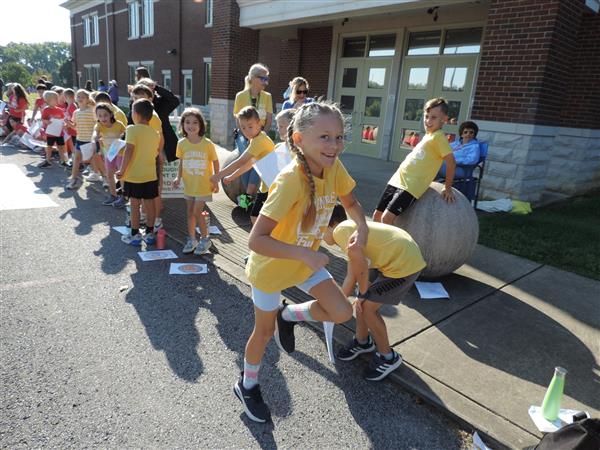 students running in yellow shirts